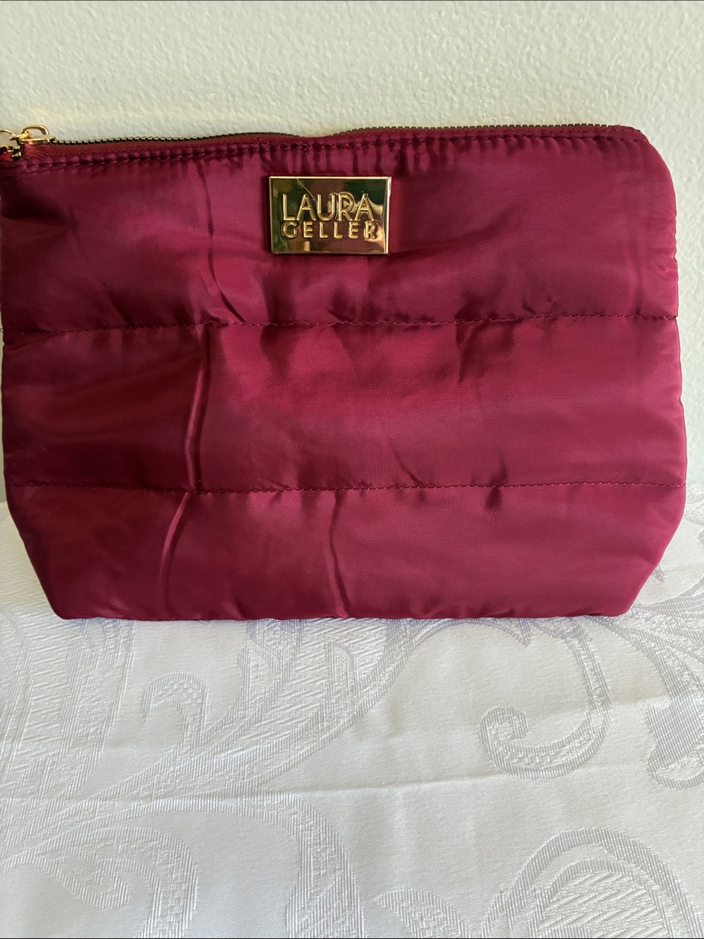 Laura Geller Quilted Wine Red Cosmetic Pouch with Gold Logo
